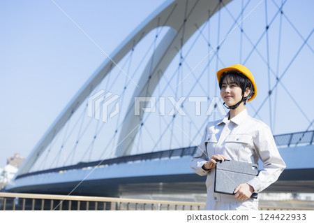 Woman in work clothes at a construction site 124422933