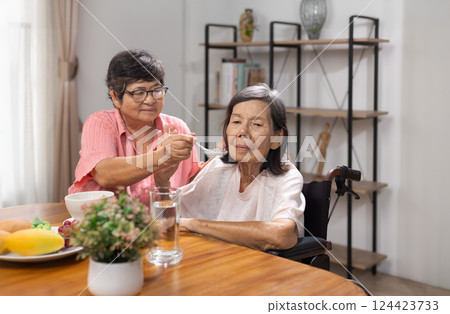 Senior asian woman bored with food. Senior asian woman bored with food. 124423733