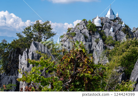 Group of the pagodas on limestone mountains in Wat Chaloem Phra Kiat Phrachomklao Rachanusorn in Lampang province of Thailand. 124424399