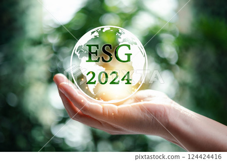 Hand holding globe with 2024 green ESG on nature background. 2024 Green business, environmental social governance sustainability. Carbon offset and neutrality strategies. Saving environment. Hand holding globe with 2024 green ESG on nature background. 2024 Green business, environmental social governance sustainability. Carbon offset and neutrality strategies. Saving environment. 124424416