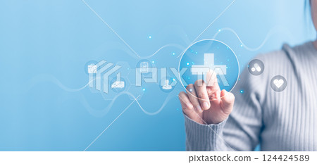 Woman hand touching plus with healthcare medical icon on blue sky background. Health insurance health concept. Access to welfare health and copy space, benefit pharmacy, plan community treatment. 124424589