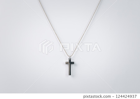 Silver necklace with cross. Cross isolated on white background. Christian cross and silver chain isolated on white background. 124424937
