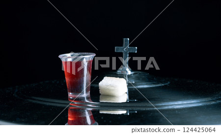 Eucharist or holy Communion of christianity concept. Eucharist is sacrament instituted by Jesus. during last supper with disciples. Bread and wine is body and blood of Jesus Christ of Christians. 124425064