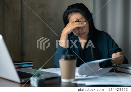 Tired business woman sleepy and bored from sitting at a desk for a long time and has office syndrome. Stressed business woman. Bored woman in office working with laptop and staring at computer screen Tired business woman sleepy and bored from sitting at a desk for a long time and has office syndrome. Stressed business woman. Bored woman in office working with laptop and staring at computer screen 124425532