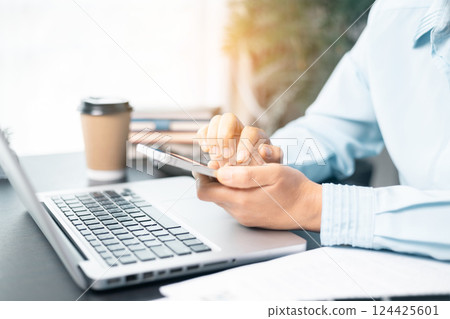 Business woman working on documents looking concentrated with briefcase on table. Businesswoman is deeply reviewing a financial report for a return on investment or investment risk analysis. Business woman working on documents looking concentrated with briefcase on table. Businesswoman is deeply reviewing a financial report for a return on investment or investment risk analysis. 124425601
