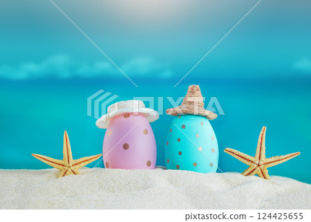 Blue and pink eggs in hats with starfish on the sand of the beach, beyond the sea. Easter in hot countries. Copy space Blue and pink eggs in hats with starfish on the sand of the beach, beyond the sea. Easter in hot countries. Copy space 124425655