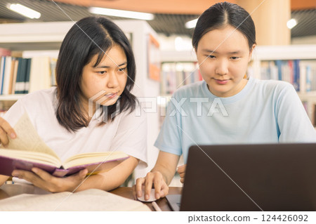 Two young woman, a dedicated student, navigates university life with her friend, embracing education and growth as they pursue their goals together. female student in college Two young woman, a dedicated student, navigates university life with her friend, embracing education and growth as they pursue their goals together. female student in college 124426092