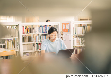 Young student eagerly enters the classroom, ready to immerse themselves in world of learning and education at college, studying books alongside their peers in university. Young student eagerly enters the classroom, ready to immerse themselves in world of learning and education at college, studying books alongside their peers in university. 124426094
