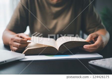 Christian online religion technology concept. Hands praying of christian with digital computer laptop, Online live church for sunday service. Asian woman praying in darkness with computer laptop. 124426175