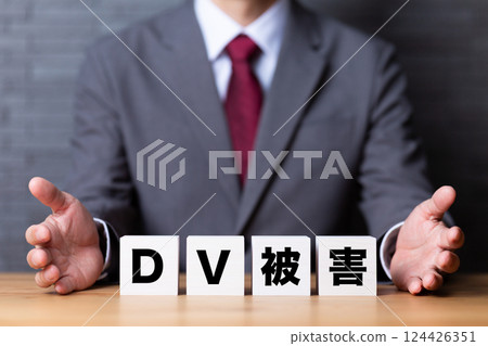 Domestic violence victim block and middle-aged male businessman in a suit 124426351