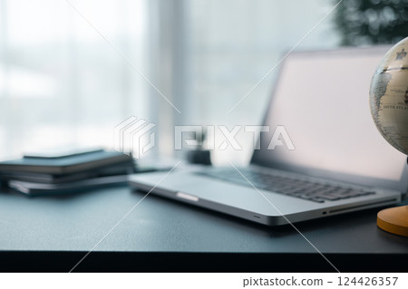 Office workplace with laptop and smart phone on wood table. Workspace, desktop computer, office supplies, houseplant and books at office. desk work concept. laptop Comfortable work table in office. Office workplace with laptop and smart phone on wood table. Workspace, desktop computer, office supplies, houseplant and books at office. desk work concept. laptop Comfortable work table in office. 124426357