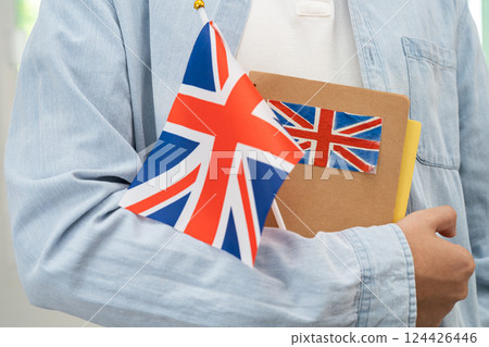 Learn English language, Asian teenage student hold book with flag in course at school. 124426446