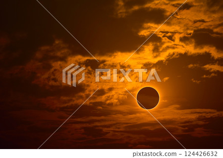 eclipse on the gold sunset sky and transparent cloud eclipse on the gold sunset sky and transparent cloud 124426632