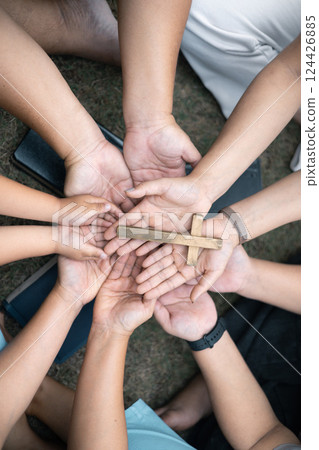Group of Christian believers clasped hands in prayer, In the church, expressing their faith through worship and reverence for God, symbolized by the cross. Group christian pray concept. Group of Christian believers clasped hands in prayer, In the church, expressing their faith through worship and reverence for God, symbolized by the cross. Group christian pray concept. 124426885