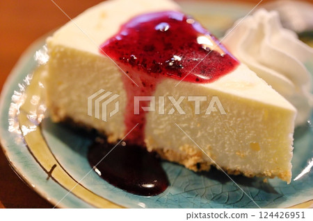 A beautiful cross section of rare cheesecake and sparkling blueberry sauce A beautiful cross section of rare cheesecake and sparkling blueberry sauce 124426951