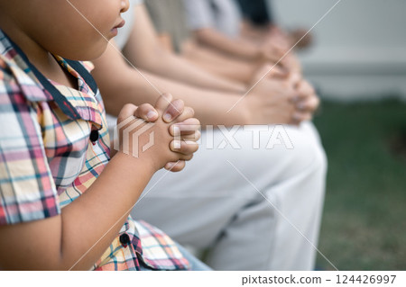 Christian woman held hands with the group, expressing their faith through prayer and devotion to God, uniting in their shared religion. Friends, Group christian pray concept. 124426997
