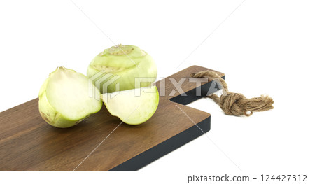 Fresh Kohlrabi Pieces on a Wooden Cutting Board with Rope Handle 124427312