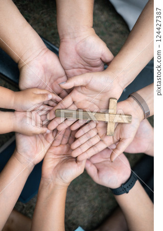 Group of Christian believers clasped hands in prayer, In the church, expressing their faith through worship and reverence for God, symbolized by the cross. Group christian pray concept. Group of Christian believers clasped hands in prayer, In the church, expressing their faith through worship and reverence for God, symbolized by the cross. Group christian pray concept. 124427387