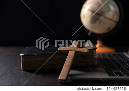 Missionary embarked on mission across the earth, armed with faith in Jesus Christ and a map, spreading the teachings of Christianity and the Bible to fulfill God's call within the Christian religion. 124427558