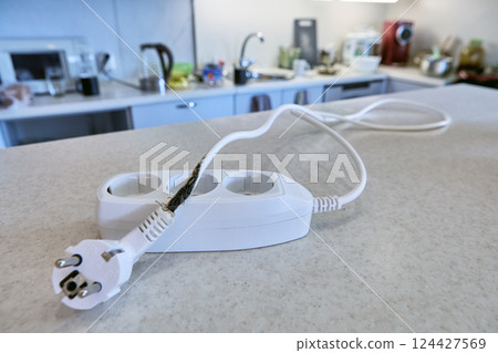 Overload destroyed extension cord, which burned power cable, causing short circuit and almost causing fire. 124427569