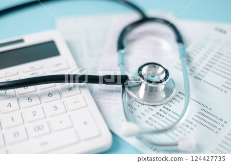 Stethoscope symbolizes essential medical care provided within health care system, health insurance plays crucial role in financing treatment and medicine to disease, concept of health management. 124427735