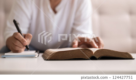Christian woman with faith and hope, raises her hand in worship to pray to God and Jesus Christ, embodying her religion. woman, hand, faith, pray, worship, jesus christ, christian, god, hope. 124427751