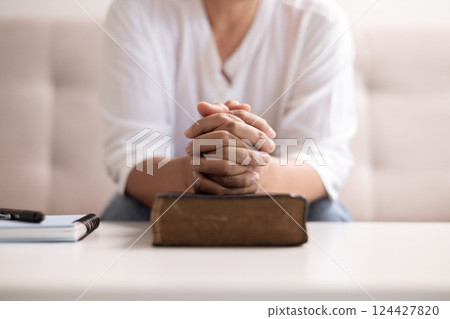 Christian woman with faith and hope, raises her hand in worship to pray to God and Jesus Christ, embodying her religion. woman, hand, faith, pray, worship, jesus christ, christian, god, hope. 124427820