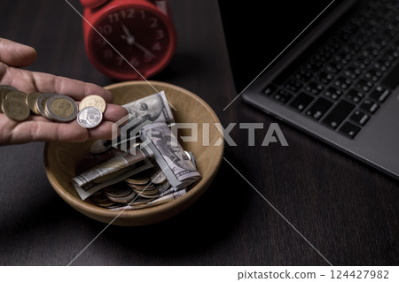 She felt deep sense of fulfillment when donating money to church, placing her tithe of coins and cash into offering bowl, knowing her giving would help fund important causes. donating, money, tithe. 124427982