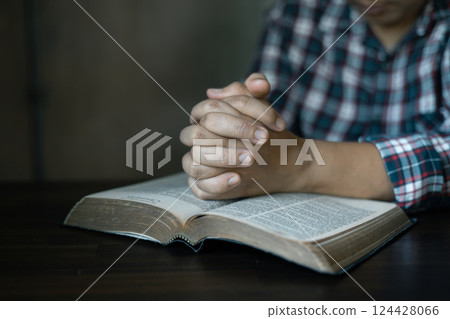Christian congregation gathered at church, each hand holding Bible, Unwavering faith, prayer and hope, seeking guidance of God through holy prayers. believers to worship, faith in Jesus Christ. Christian congregation gathered at church, each hand holding Bible, Unwavering faith, prayer and hope, seeking guidance of God through holy prayers. believers to worship, faith in Jesus Christ. 124428066