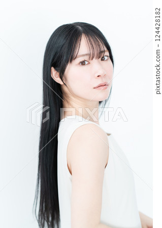 Beauty image of a young woman with long hair standing sideways Beauty image of a young woman with long hair standing sideways 124428182
