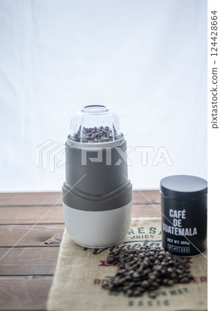 Electric mill grinds roasted beans Electric mill grinds roasted beans 124428664