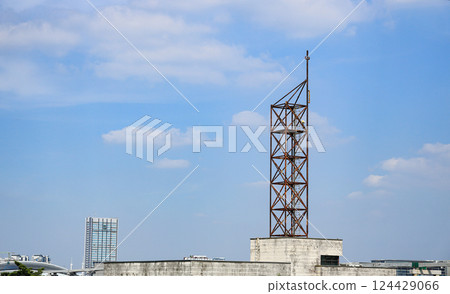 abandon or deprecated of Wireless Communication Antenna pole, Mobile phone mast antenna pole on top of dilapidated building 124429066