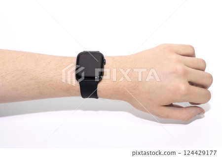 Black smart watch on the wrist of a human hand. 124429177
