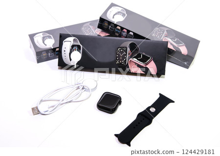 Black smart watch bracelet and charger on white background. 124429181