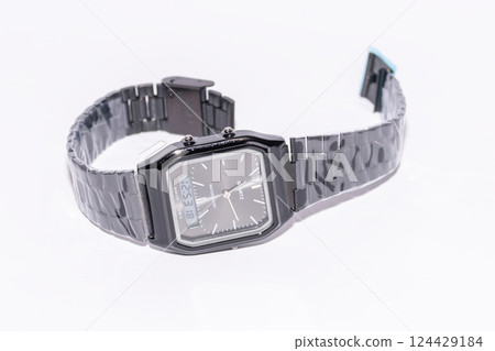 Black watch with hands and electronic dial on white background. 124429184