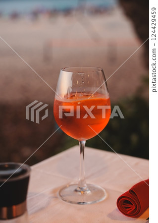 Enjoy a Refreshing Cocktail by the Beach during the Beautiful Sunset Hours by the Ocean Enjoy a Refreshing Cocktail by the Beach during the Beautiful Sunset Hours by the Ocean 124429459