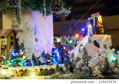 A delightful Holiday Village adorned with enchanting Snow and a mesmerizing Lights Display 124429476