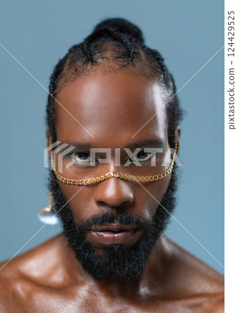 Gay man with eyeshadows and golden accessory on Gay man with eyeshadows and golden accessory on 124429525