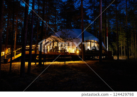 Charming EcoFriendly Cabin Nestled in a Serene Forest Surrounded by Nature at Night Charming EcoFriendly Cabin Nestled in a Serene Forest Surrounded by Nature at Night 124429798