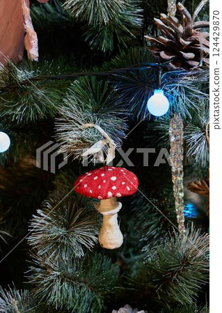 A Festive Mushroom Ornament Hanging on a Christmas Tree, Adding to the Holiday Cheer 124429870