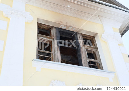 An abandoned building with burnt window frames offers unique charm for artistic photography An abandoned building with burnt window frames offers unique charm for artistic photography 124430021