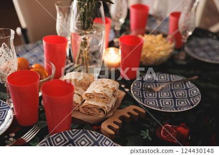 Enjoy a festive gathering with a colorful table setting and delicious snacks to share Enjoy a festive gathering with a colorful table setting and delicious snacks to share 124430148