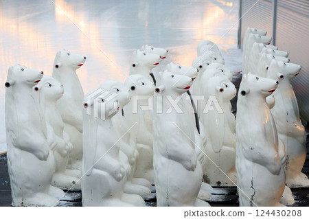 A captivating group of white polar bear statues arranged in a visually striking display A captivating group of white polar bear statues arranged in a visually striking display 124430208