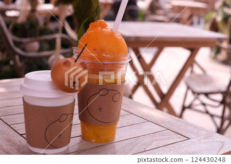 Orange juice on the cafe terrace 124430248