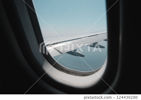 Enjoy an Aerial View Through the Airplane Window Featuring the Wing and the Beautiful Sky Enjoy an Aerial View Through the Airplane Window Featuring the Wing and the Beautiful Sky 124430280