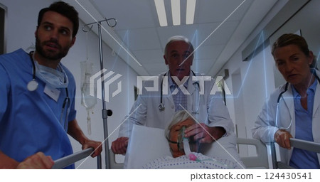 Image of cardiograph over caucasian doctors walking with patient in hospital bed Image of cardiograph over caucasian doctors walking with patient in hospital bed 124430541