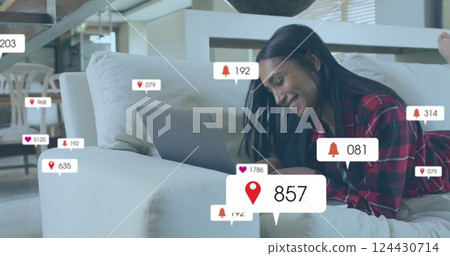 Image of icons and data processing over biracial woman using laptop Image of icons and data processing over biracial woman using laptop 124430714