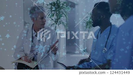 Doctors discussing patient care, virus cells image over medical professionals 124431449