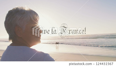 Person standing on beach with Vive la France! text image over ocean view Person standing on beach with Vive la France! text image over ocean view 124431567