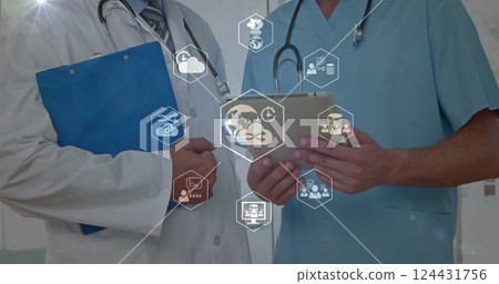 Image of business icons over caucasian male doctors using tablet 124431756